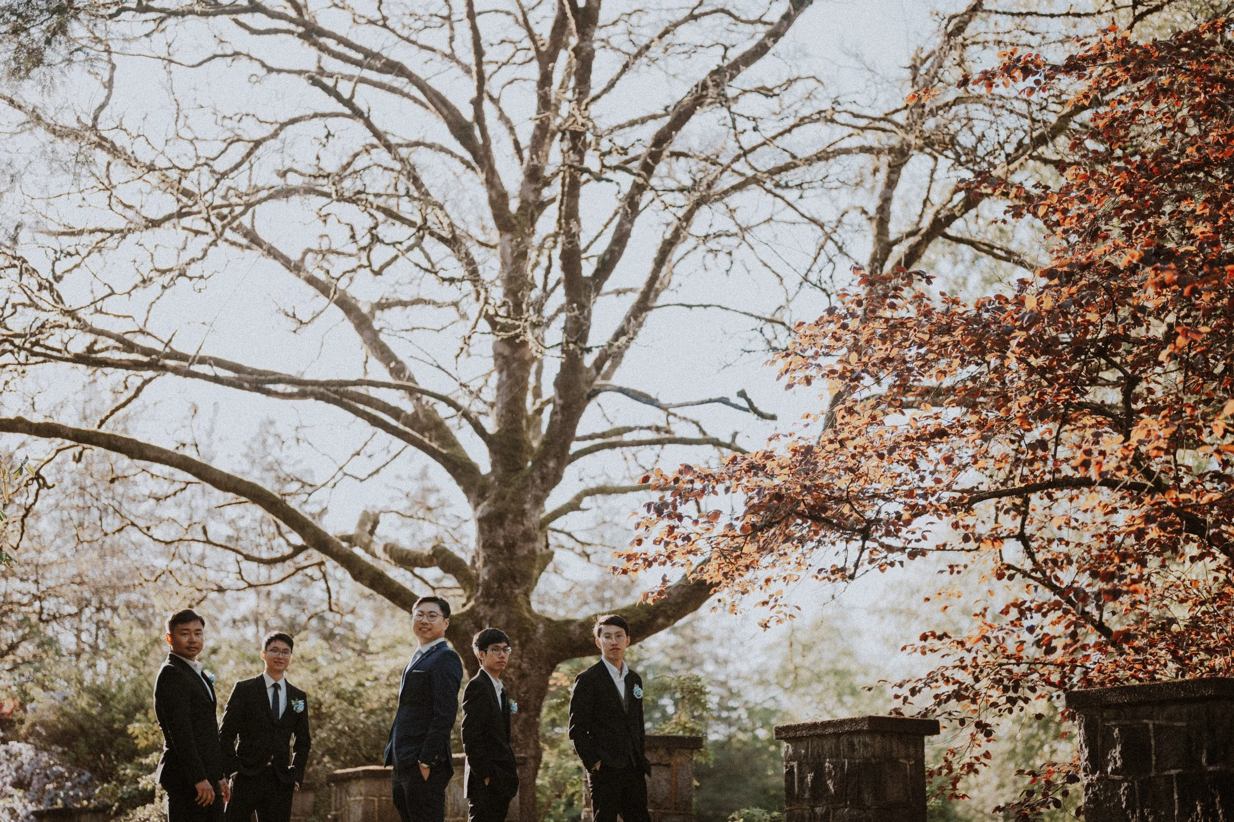  The groom and his groomsmen look sharp in their suits, framed by the beautiful autumn colors. 