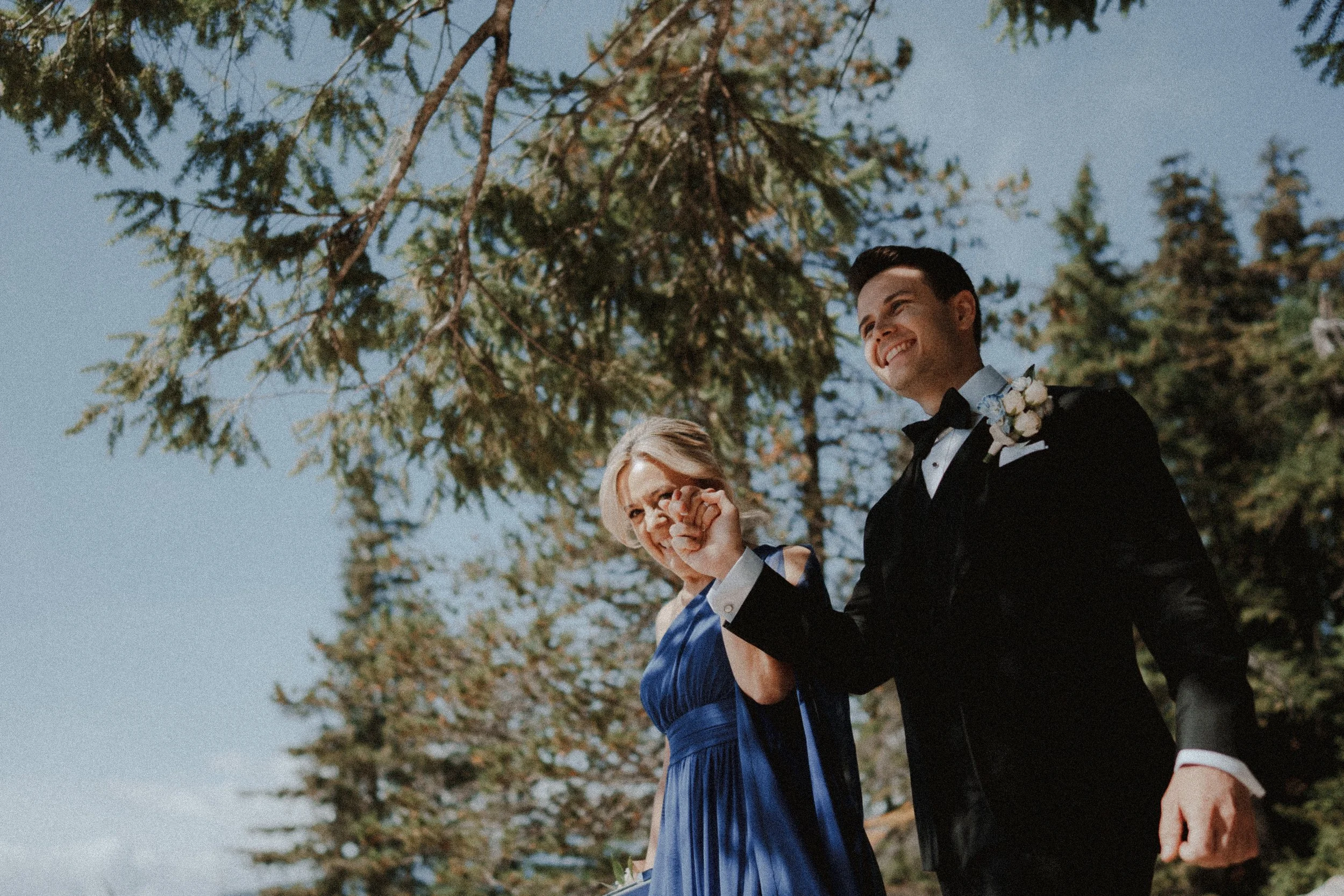  A proud moment: The groom walks toward the ceremony with his mother. Capturing the joy of the family entrance at their  Sea to Sky Gondola wedding . 