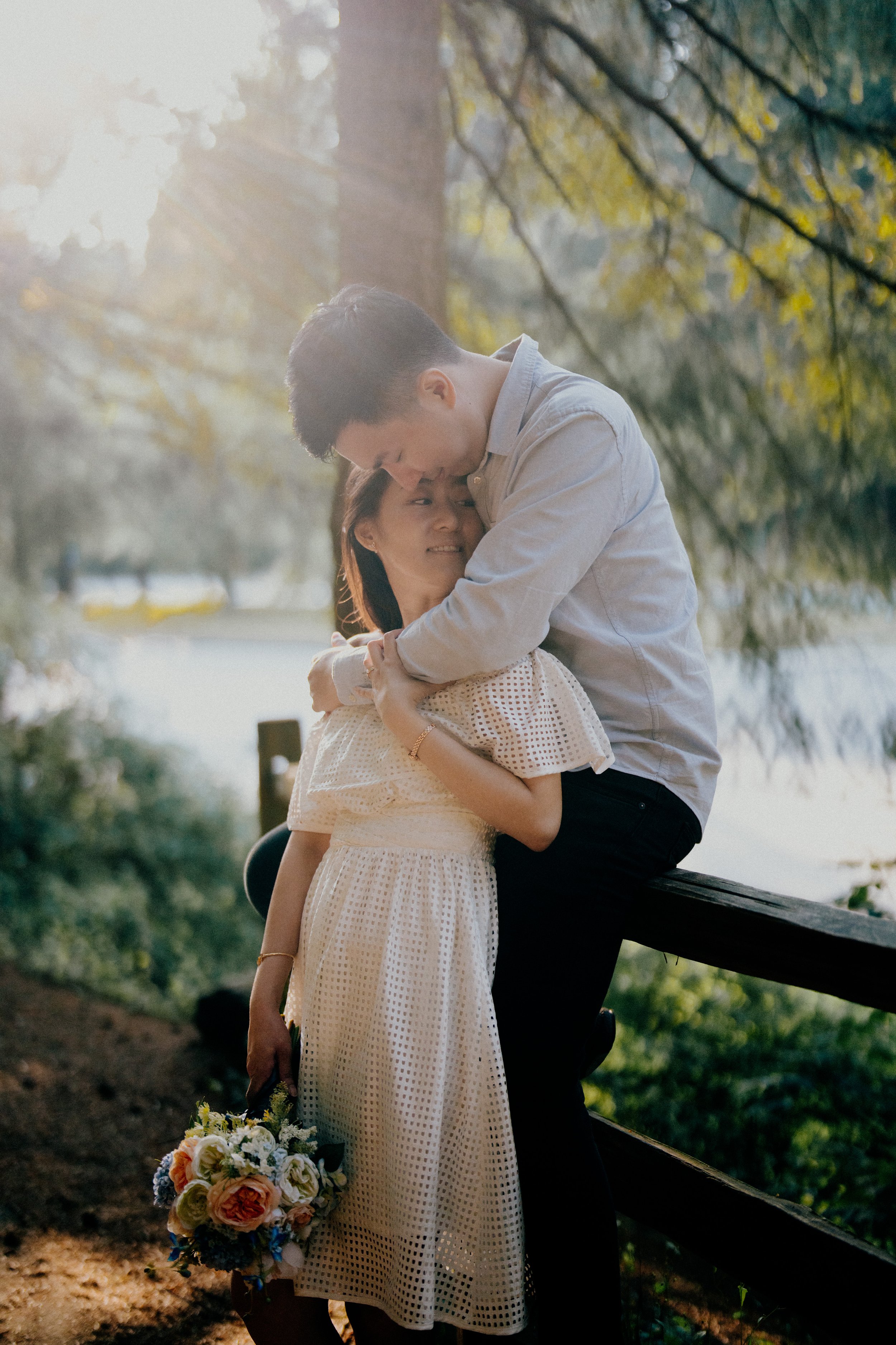  The quiet, genuine happiness of the bride embracing her groom, captured in soft forest light. 