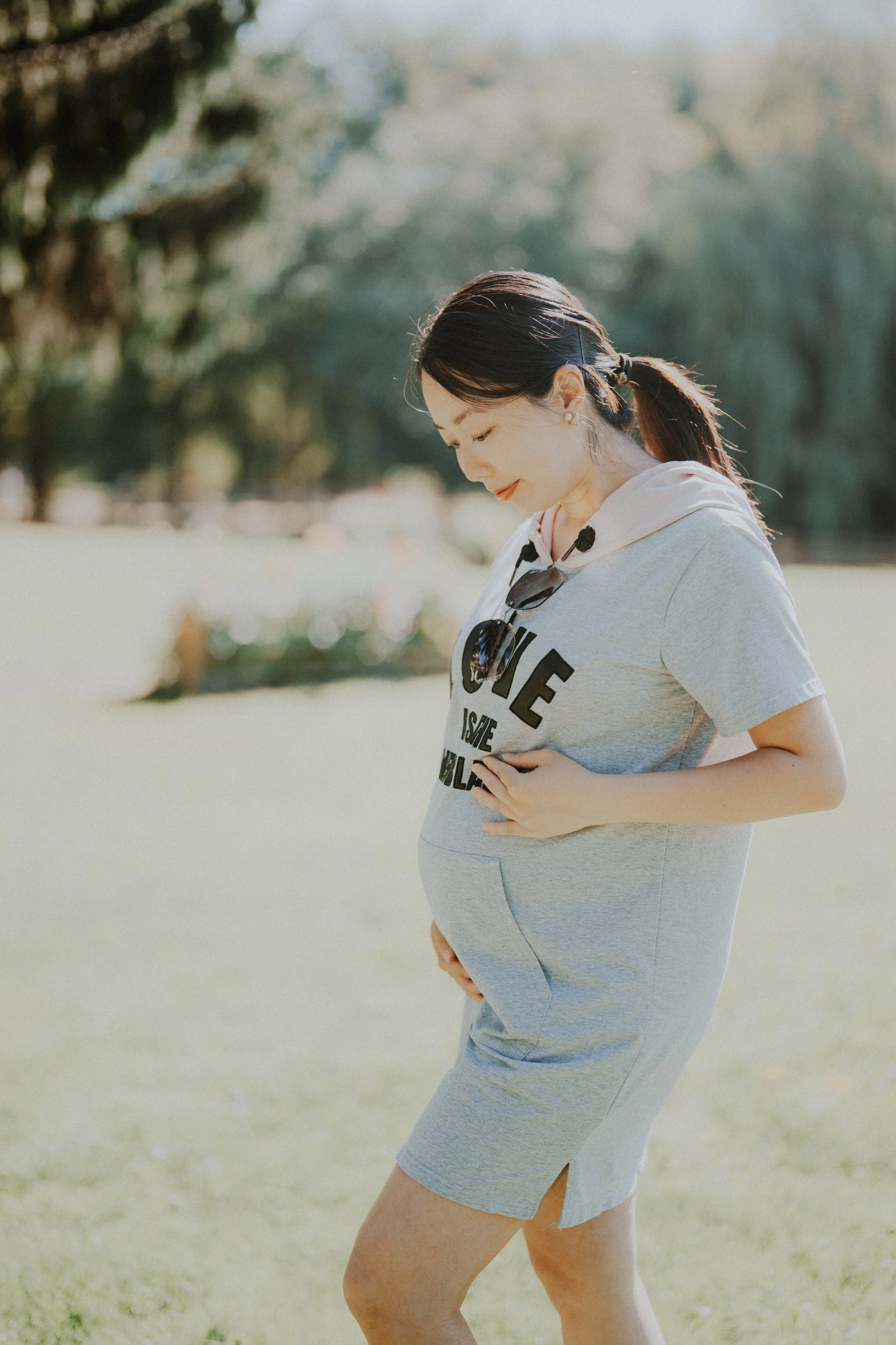 Pregnant woman standing in sunlit field at Richmond Country Farms