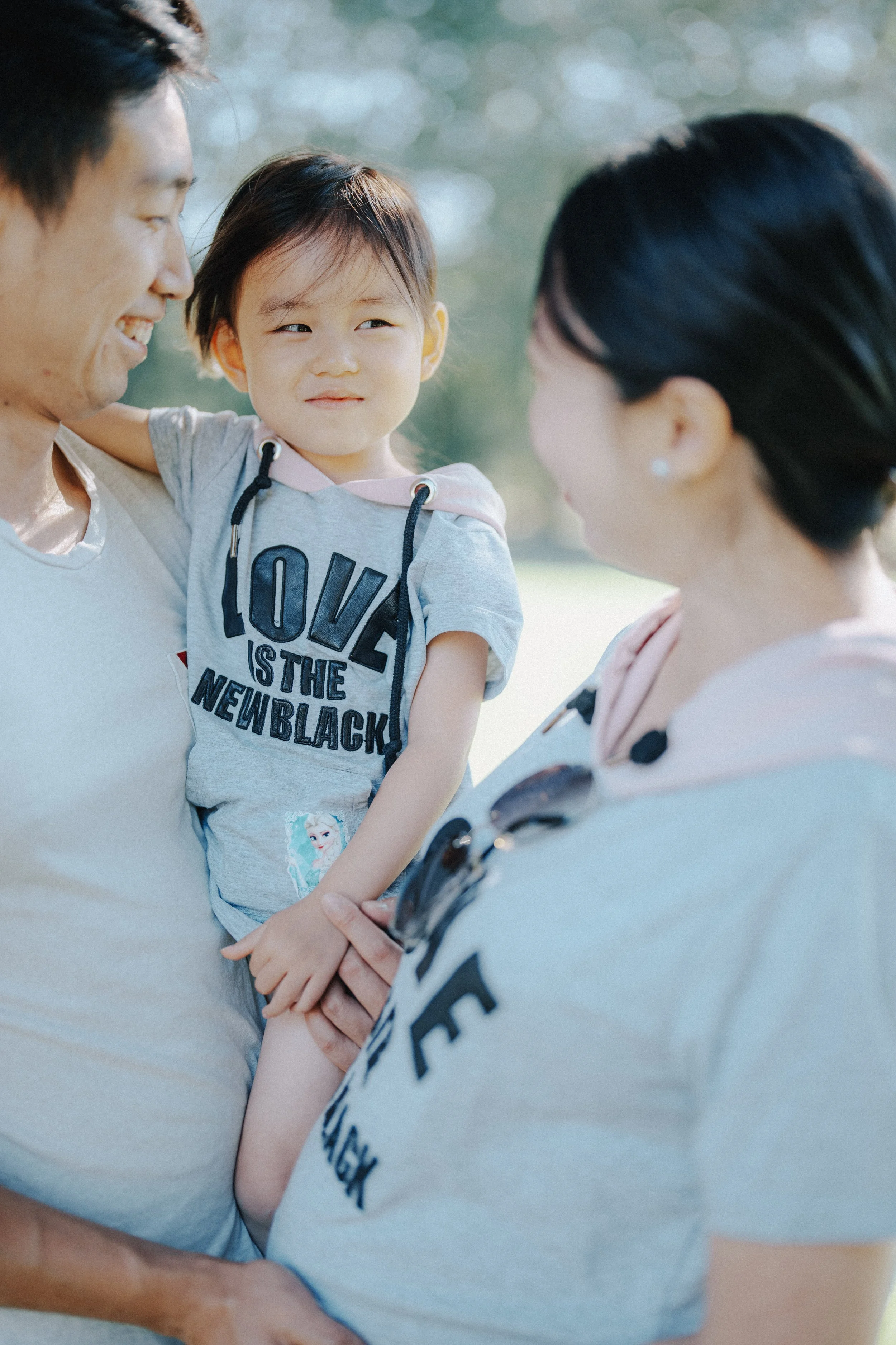 Family moment at Richmond Country Farms with child resting on shoulder