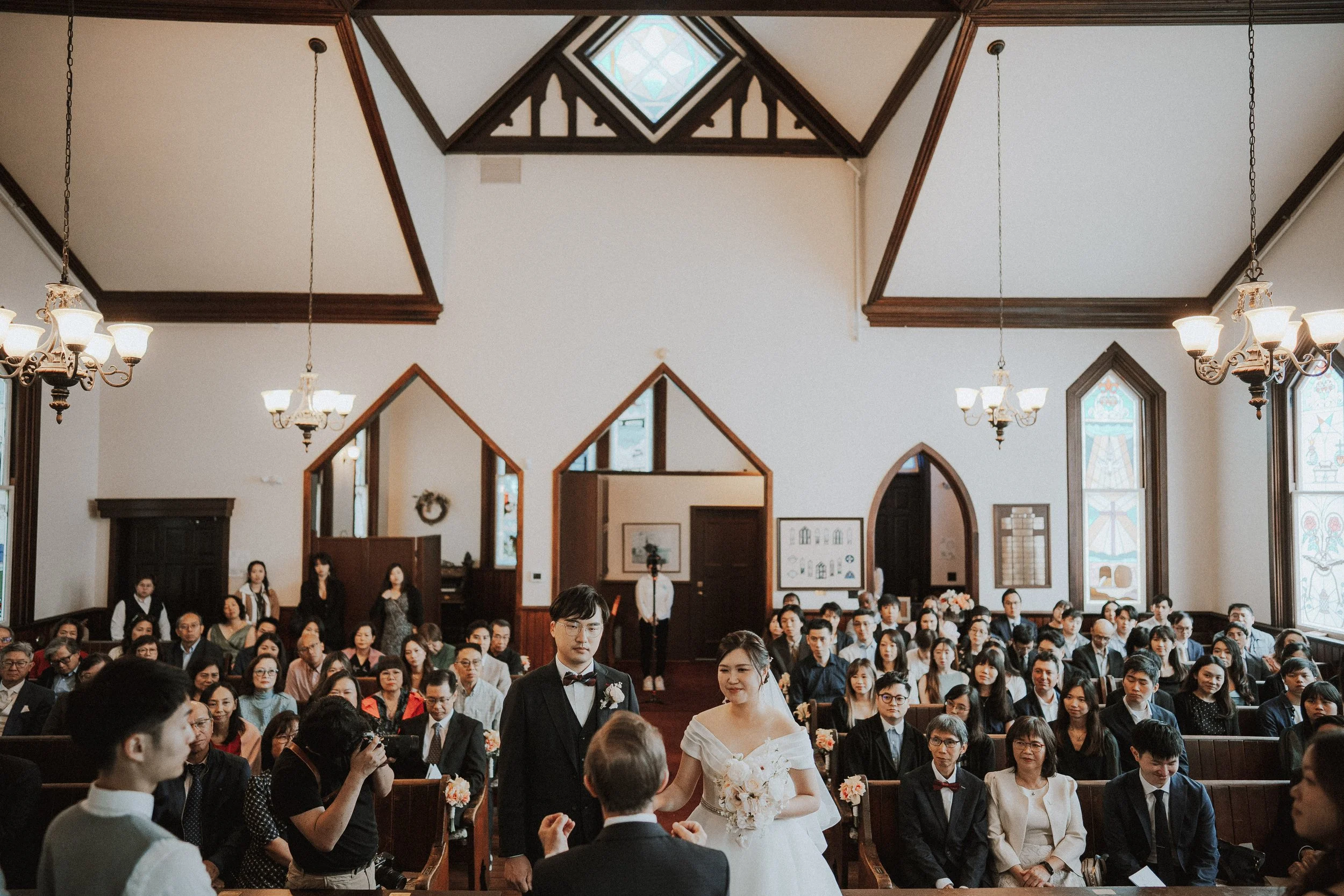  A beautiful interior shot of the historic  Minoru Chapel  during the vows, highlighting the wooden beams and unique structure. 