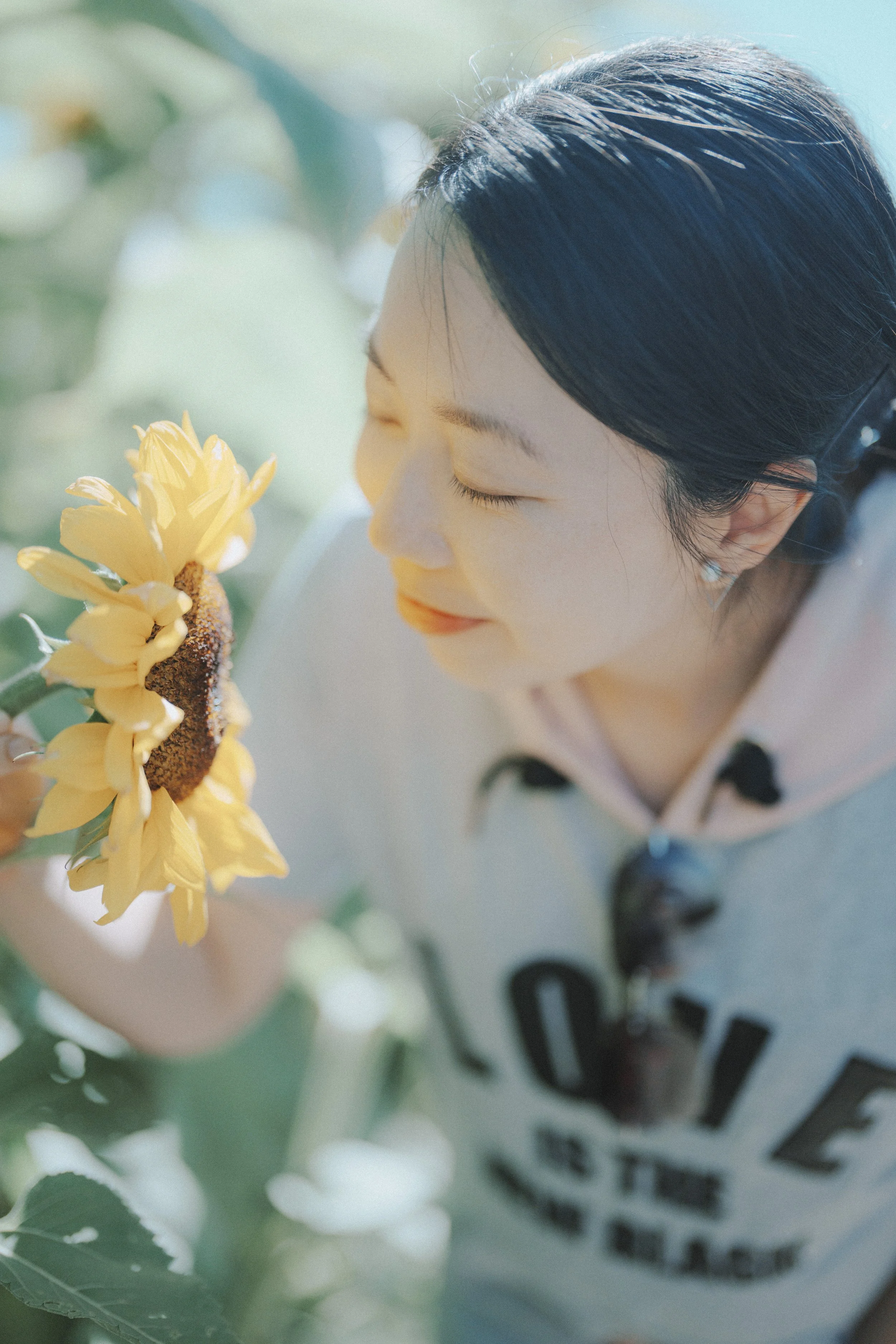 They stood together in the flowers, matching shirts and soft light all around. It felt calm and close—just a quiet moment in a beautiful place.