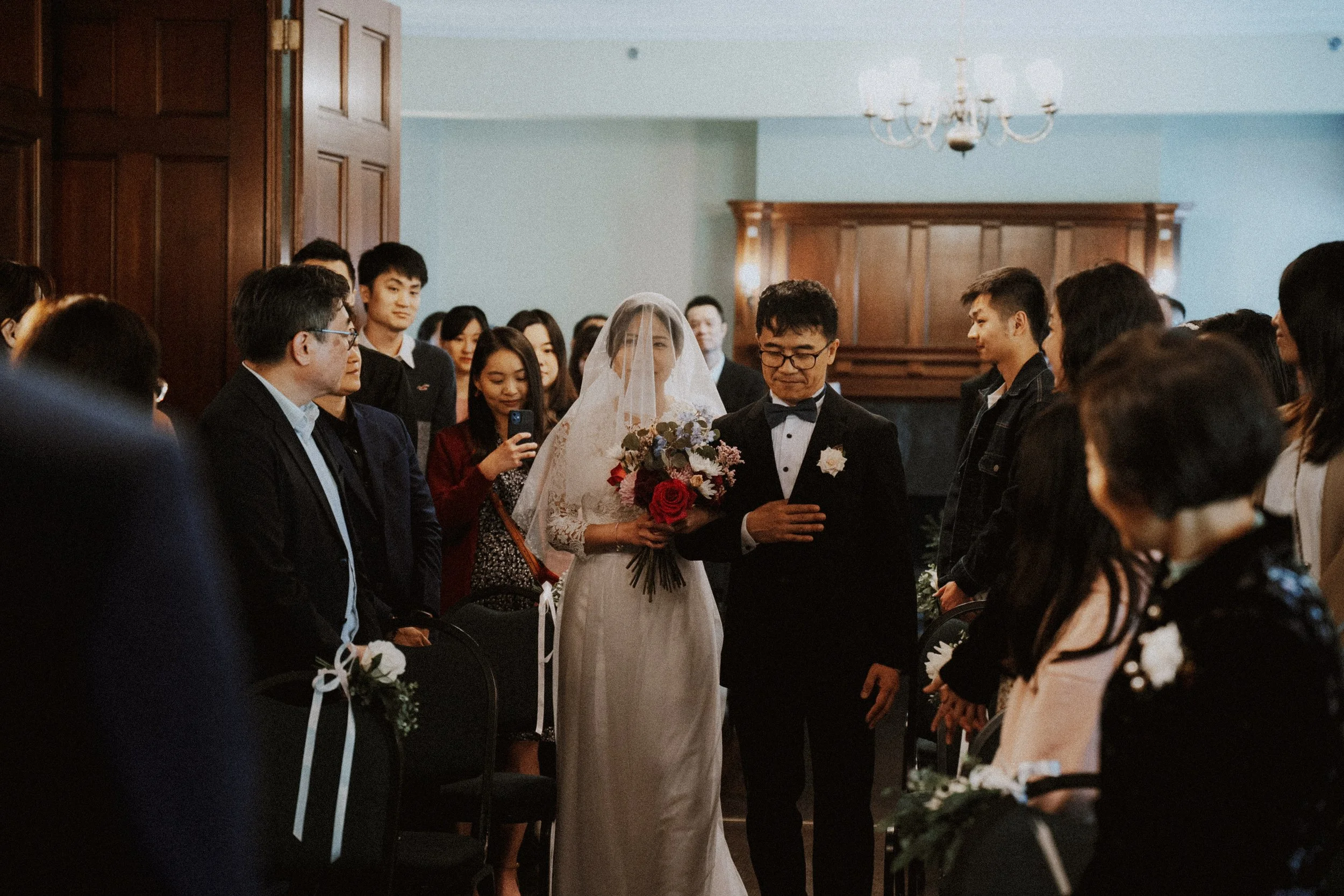  The first step: Bride and her father walking down the aisle together, ready for the wedding ceremony to begin. 