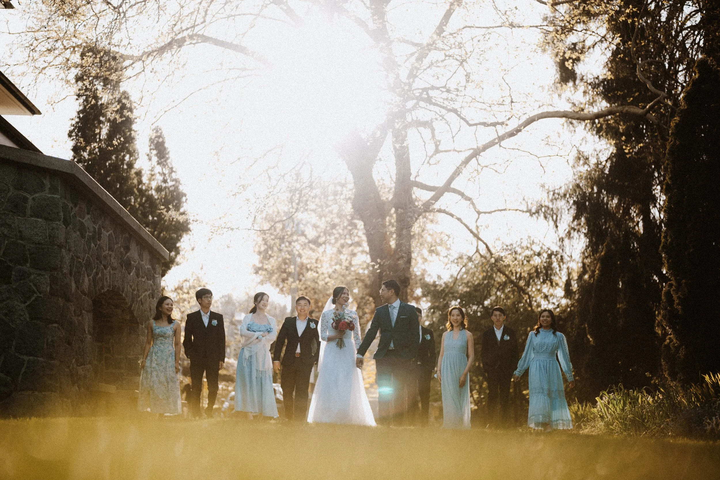  The full wedding party smiling in the beautiful golden light. A joyful group portrait taken on the grounds of  Aberthau Mansion . 