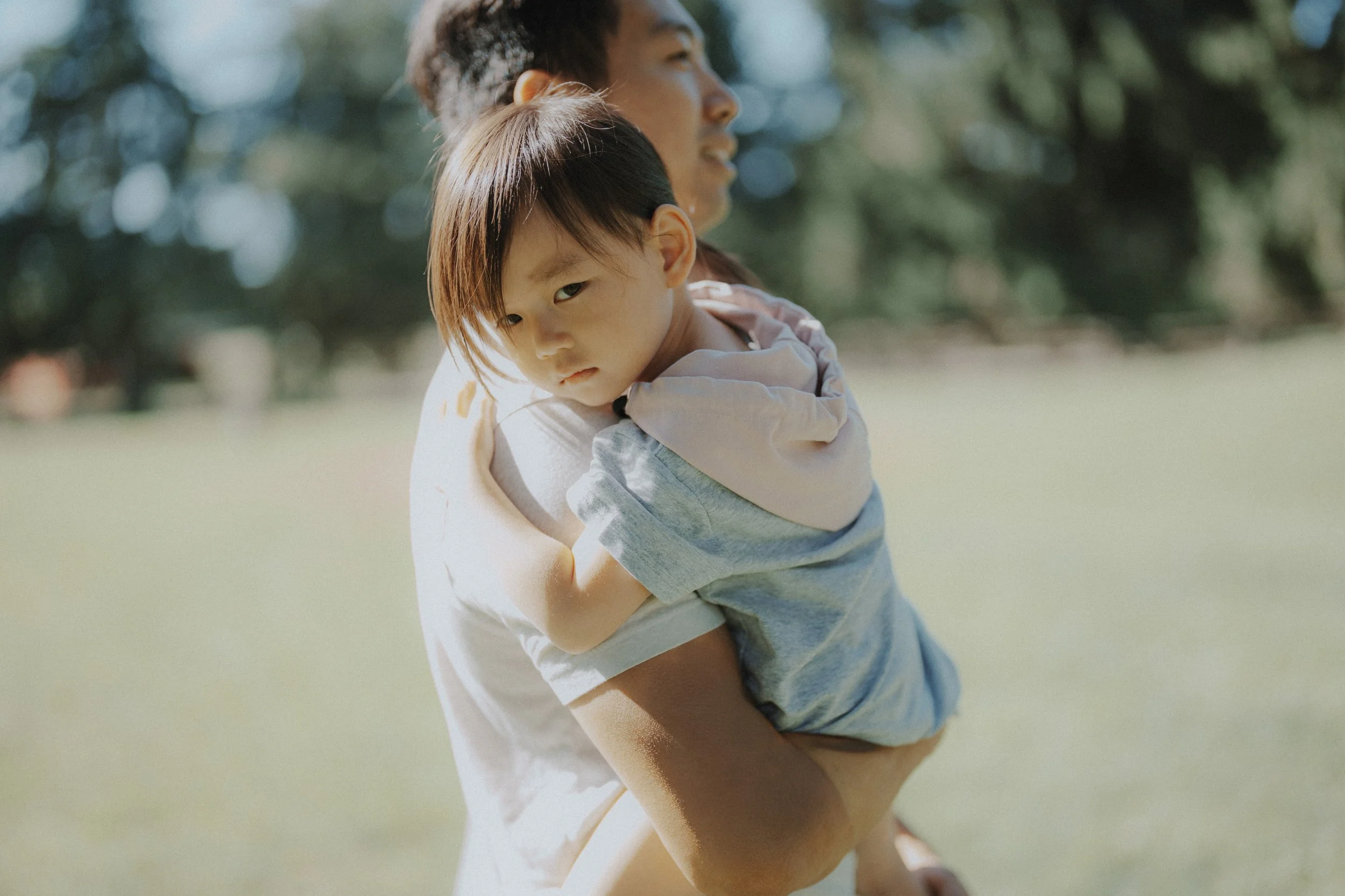 She looked straight into the lens while resting on my shoulder. I didn’t ask her to pose—she just did. The light was soft, and everything felt quiet. I love how natural this turned out.