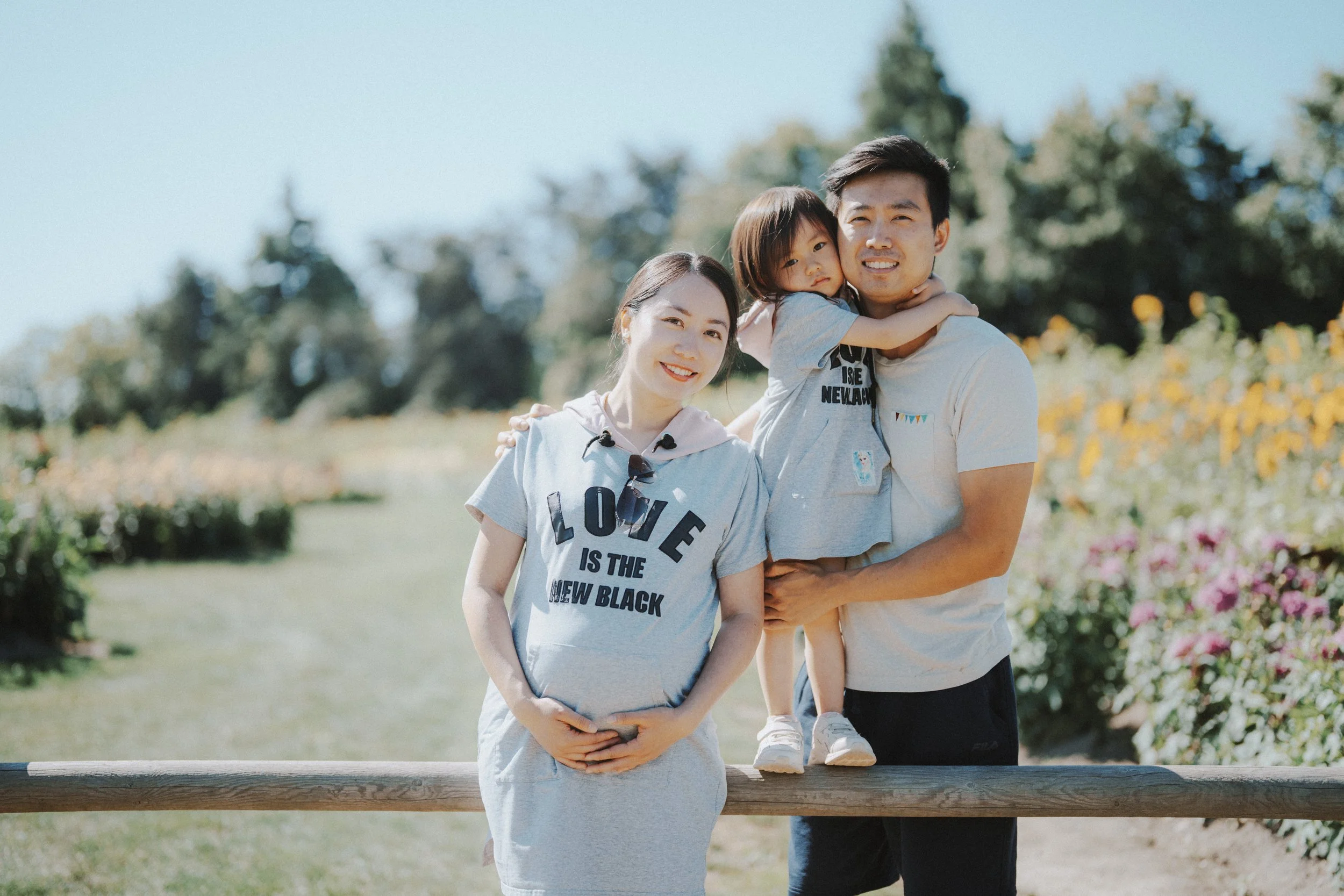  They stood together in the flowers, matching shirts and soft light all around. It felt calm and close—just a quiet moment in a beautiful place. 