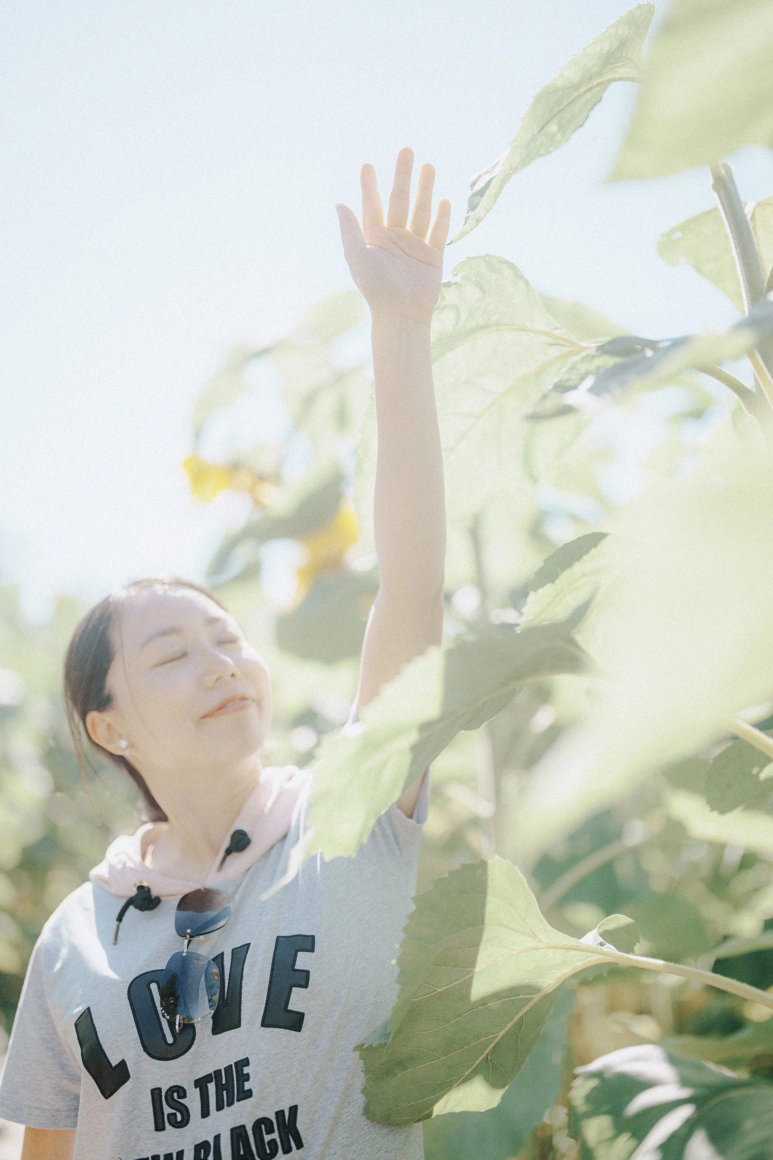  She lifted her arm and closed her eyes. The light, the plants, the quiet around her—it felt like a breath. I wanted to hold onto that stillness.   