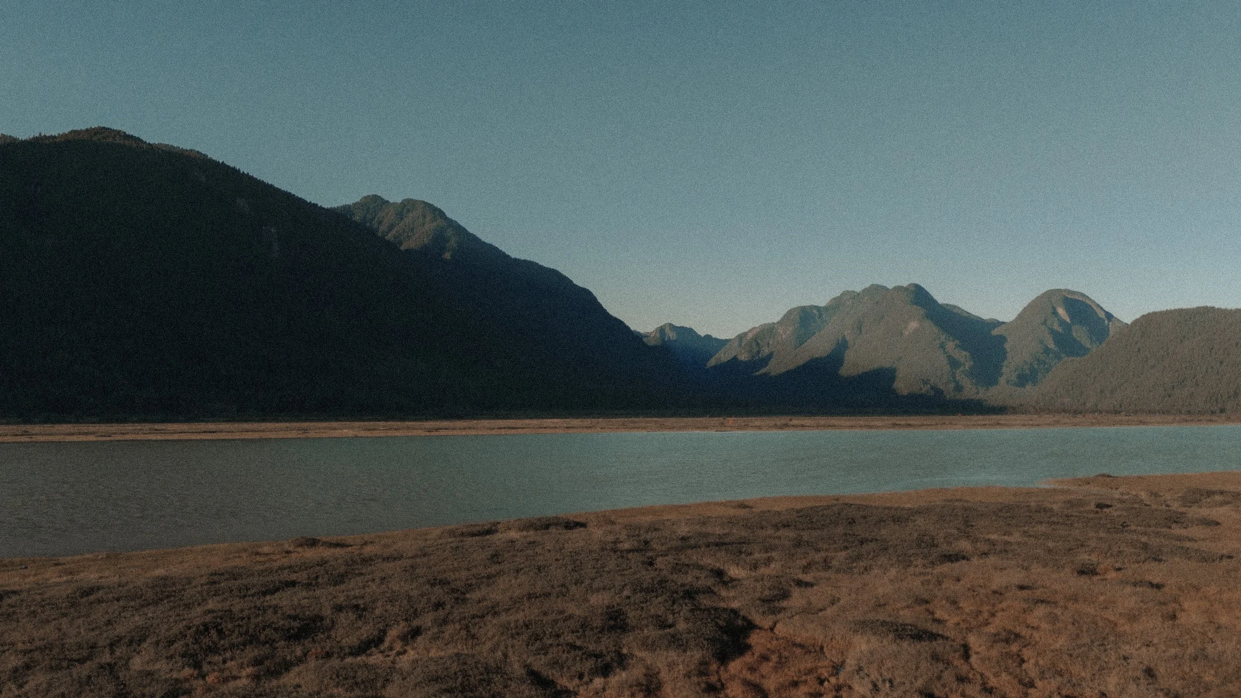  The majestic, serene landscape of  Pitt Lake , showcasing the vast mountains and calm water. 