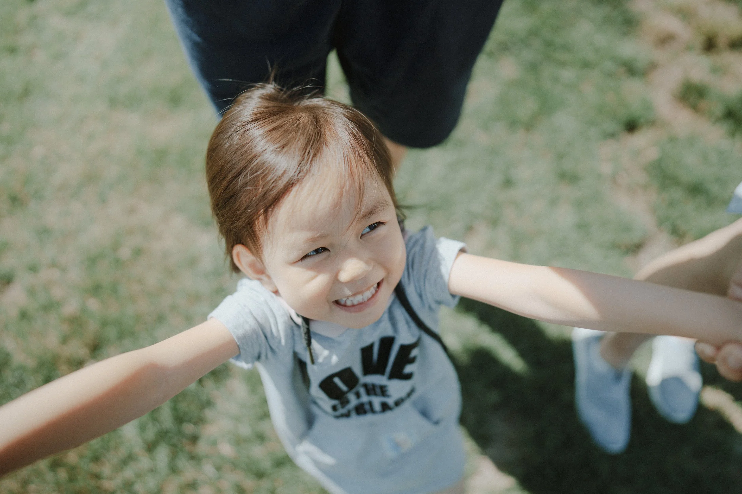  She stretched her arms and smiled so wide. Holding hands, standing in the grass—it was pure joy. I just followed her energy. 