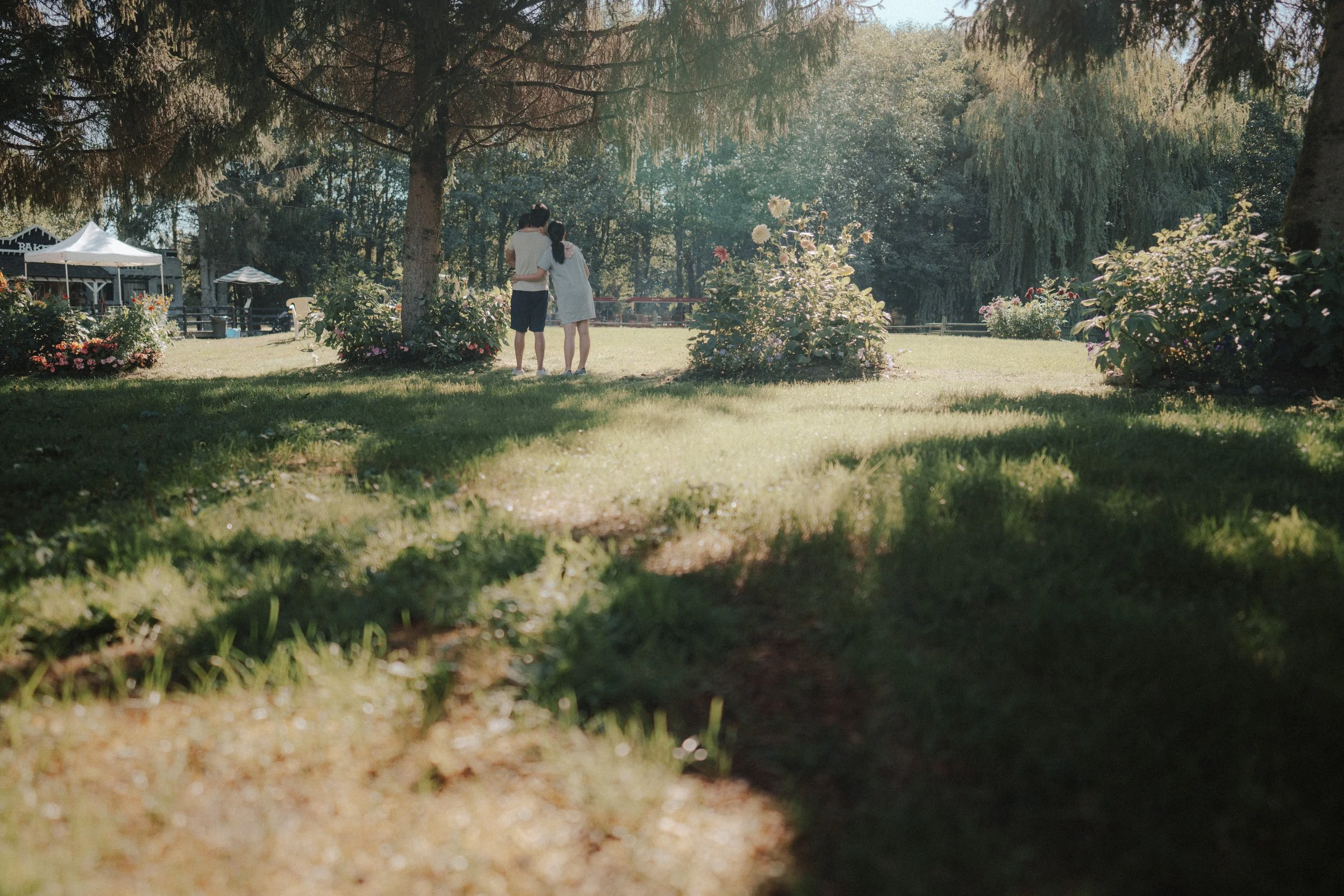 Two people standing under tree in garden at Richmond Country Farms