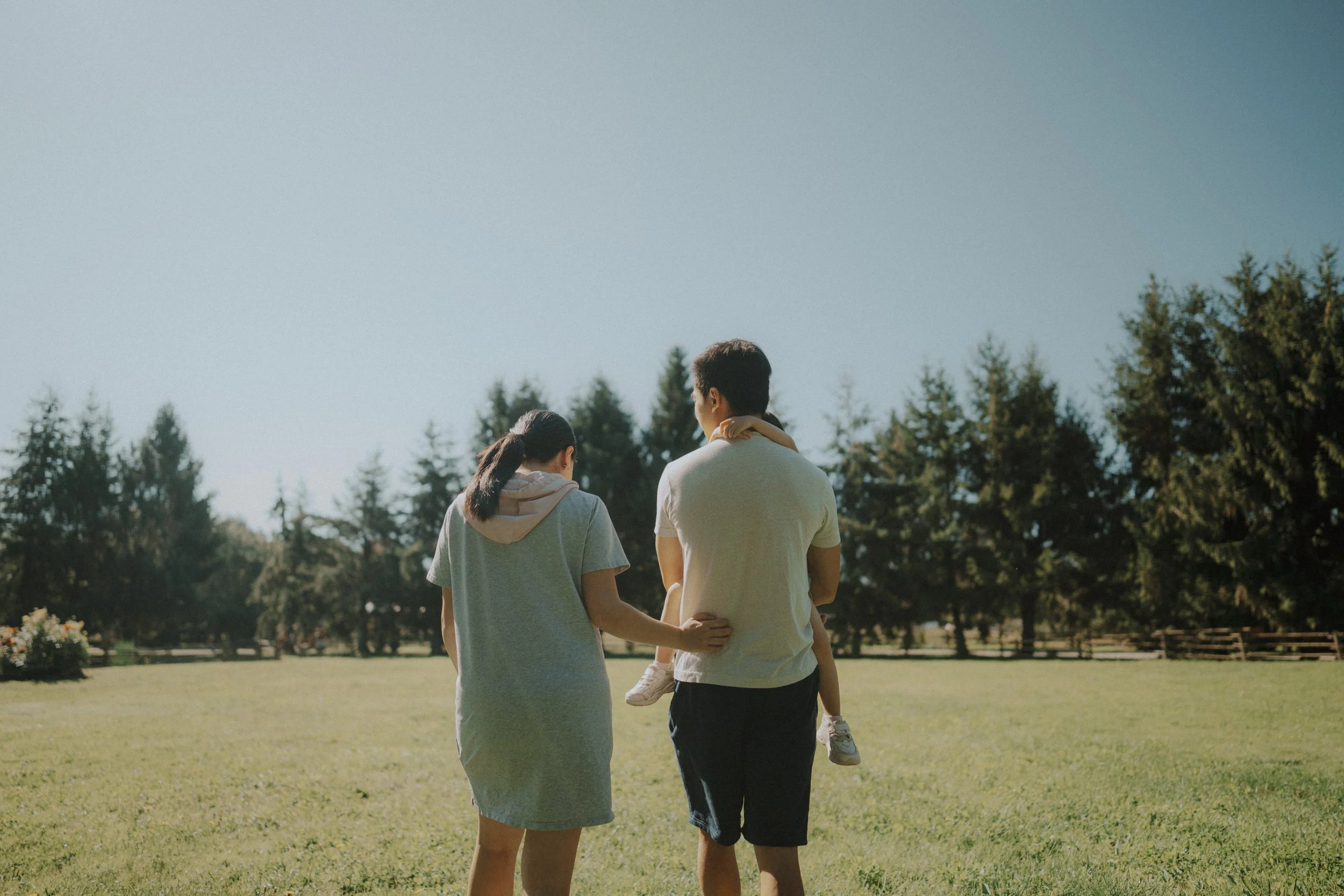 Family walking across sunlit field at Richmond Country Farms