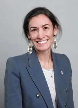Rachelle Love, a woman with brown hair and earrings