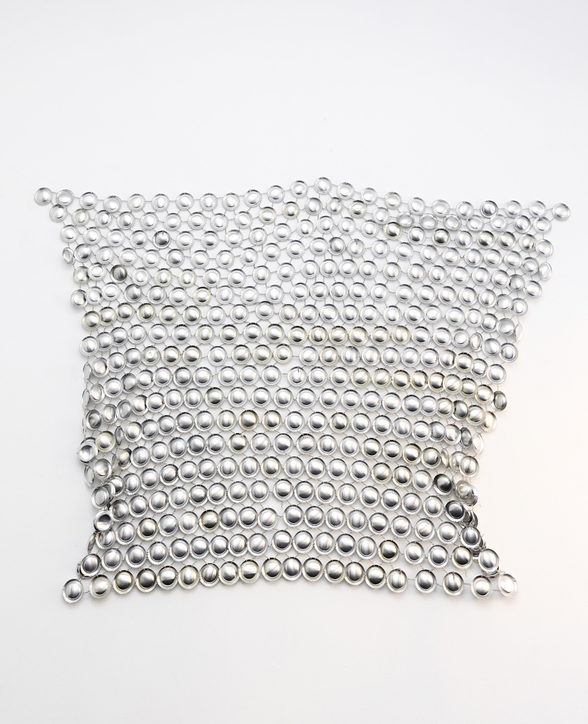 OBSESSIVE CONSUMPTION I   
Artist consumed aluminum can bottom, hand linked by o rings