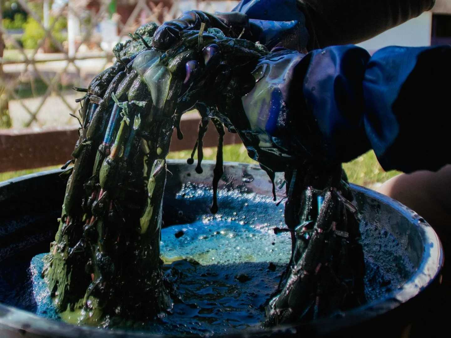 Every morning, the women at Baan Don Koi rotate through shifts to dye their woven cotton in vats of indigo. The fabric is repeatedly dipped into the soluble dye bath until it reaches the community&rsquo;s signature blue. 

The process of labor-intens