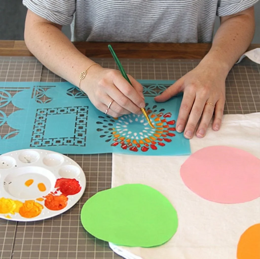 Custom stencil being painted onto fabric for textile decoration and craft applications