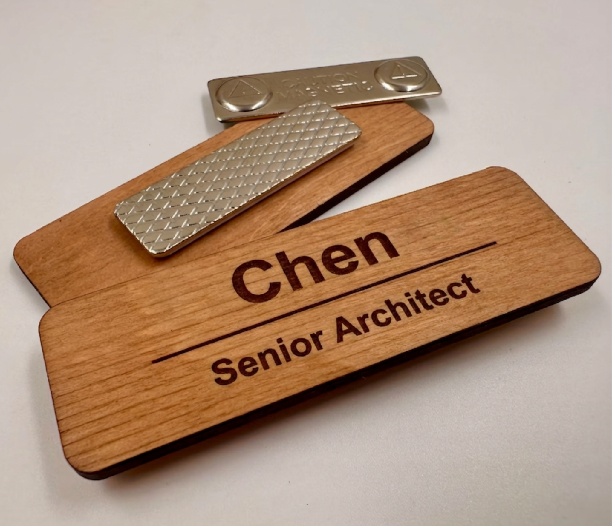 Custom wooden magnetic name badge with engraved name and job title shown with metal magnetic backing