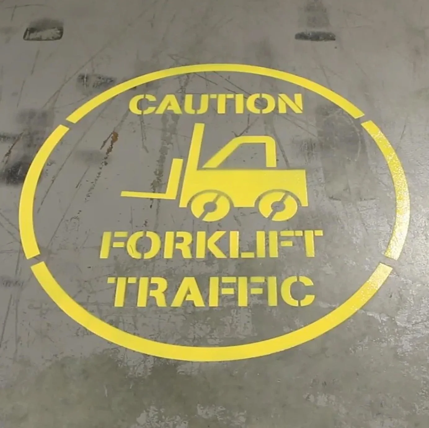 Road and safety marking stencil used for forklift traffic warning on an industrial floor