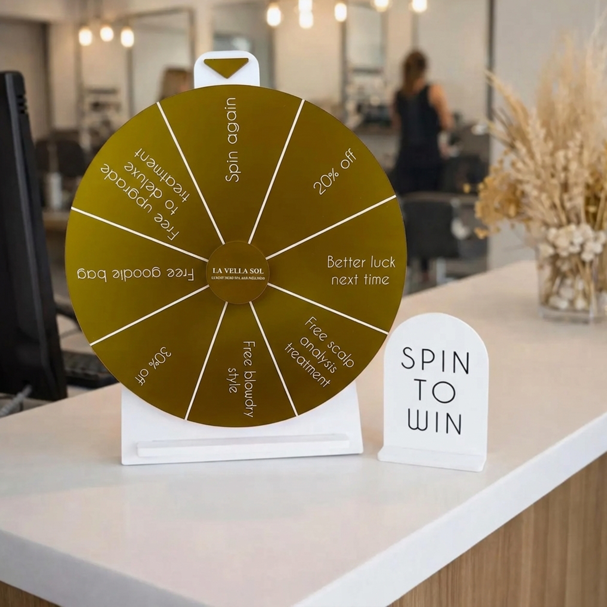 Custom countertop spin-to-win display with branded prize wheel and tabletop sign shown in a retail setting