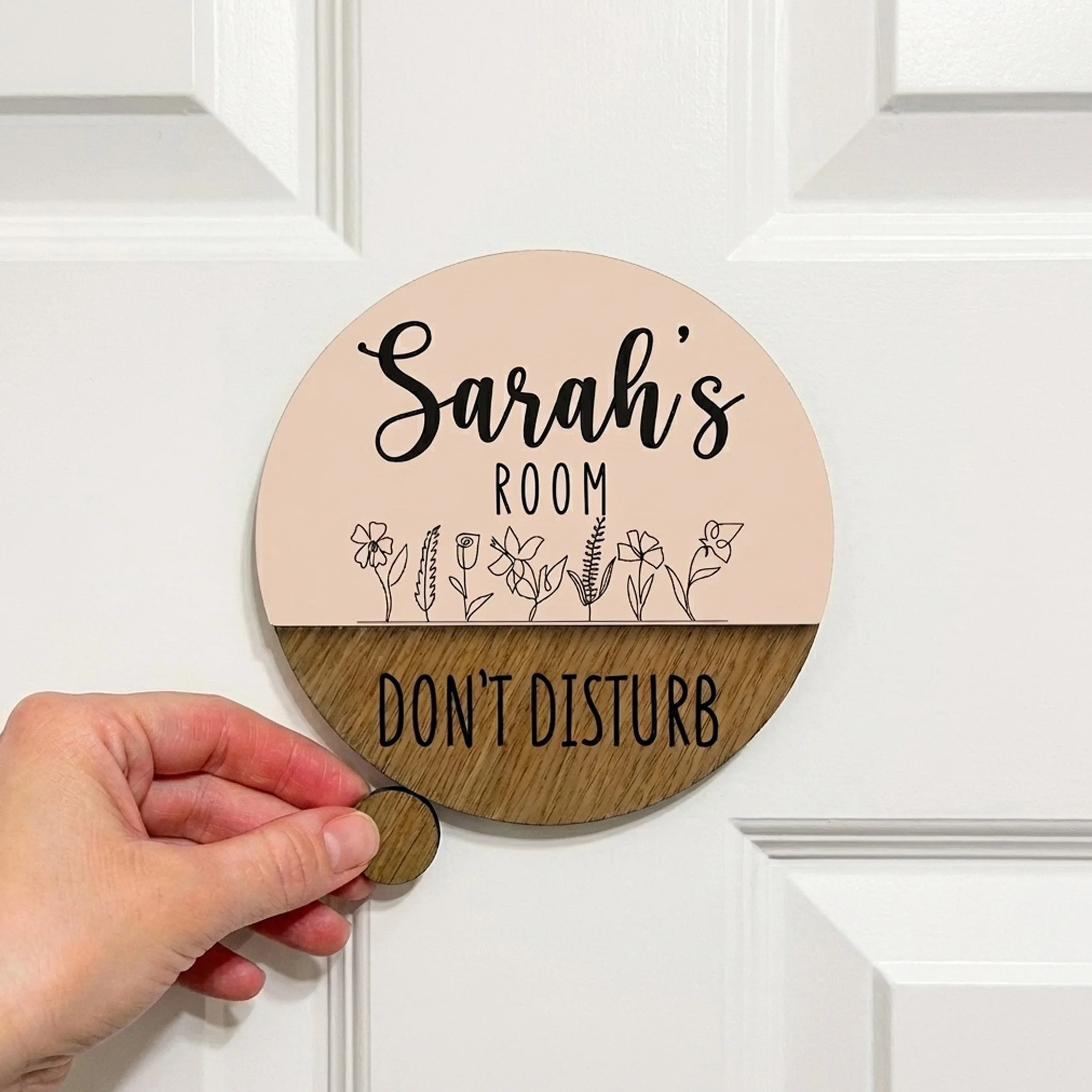 Personalised acrylic and timber door name plaque with “Do Not Disturb” slider detail mounted on a white door