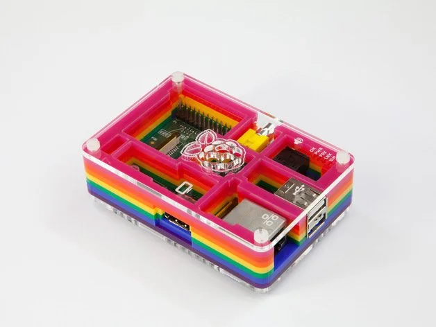 Laser-cut acrylic Raspberry Pi case with bright rainbow layers, clear panels and neatly organised internal compartments.