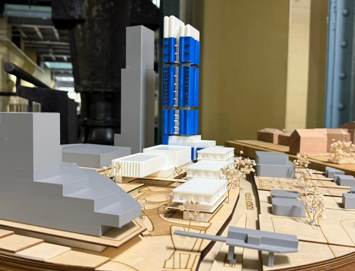 Architectural site model combining laser-cut base layers and 3D printed building forms, showing an urban development proposal.