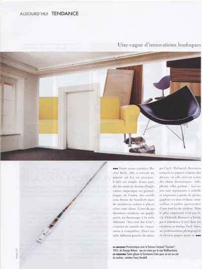 Interior room with yellow sofa and black lounge chair near window, modern decor with white trim and wooden accents.