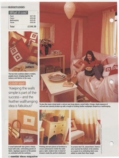 A woman sitting on a bed in a red and white themed bedroom, smiling and eating. The room features red walls, white curtains, and matching bedding with geometric patterns. Nearby is a white nightstand and a small table with decorative items. The page 