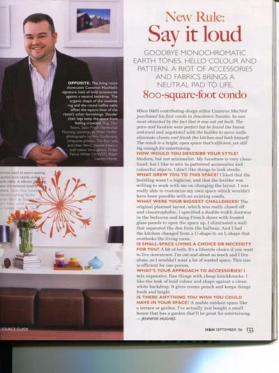 A magazine page featuring a smiling man in a blue shirt on the left side, with a house in the background. The right side contains text about home decor, including a segment titled 'New Rule: Say it loud', and additional articles about living, style, 