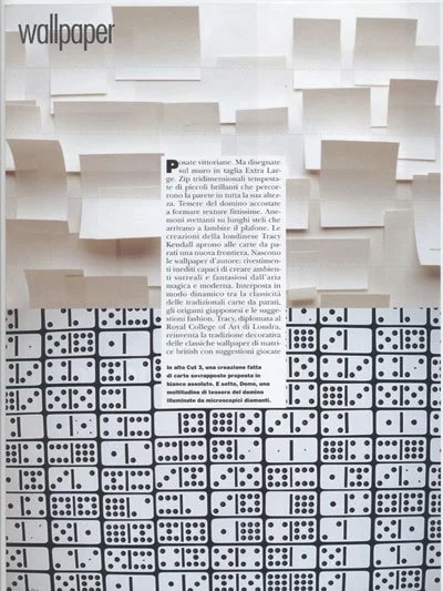 Abstract wall with three-dimensional geometric white panels at the top and a black and white domino tile pattern at the bottom, with text in the center.