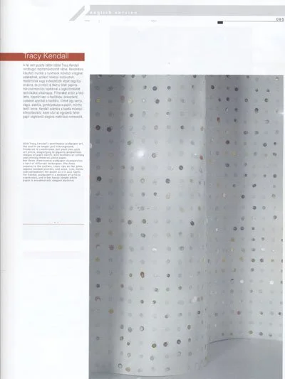A magazine page with text on the left side and a large, perforated panel on the right, featuring evenly spaced circular holes.