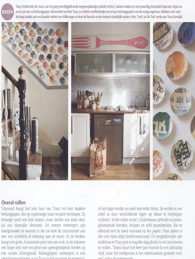 A collage of three photos: the first shows a staircase with a decorative wall featuring colorful cupcake murals, the second shows a kitchen with white cabinets, a pink spatula on the wall, and a brown paper bag on the floor, and the third displays a 
