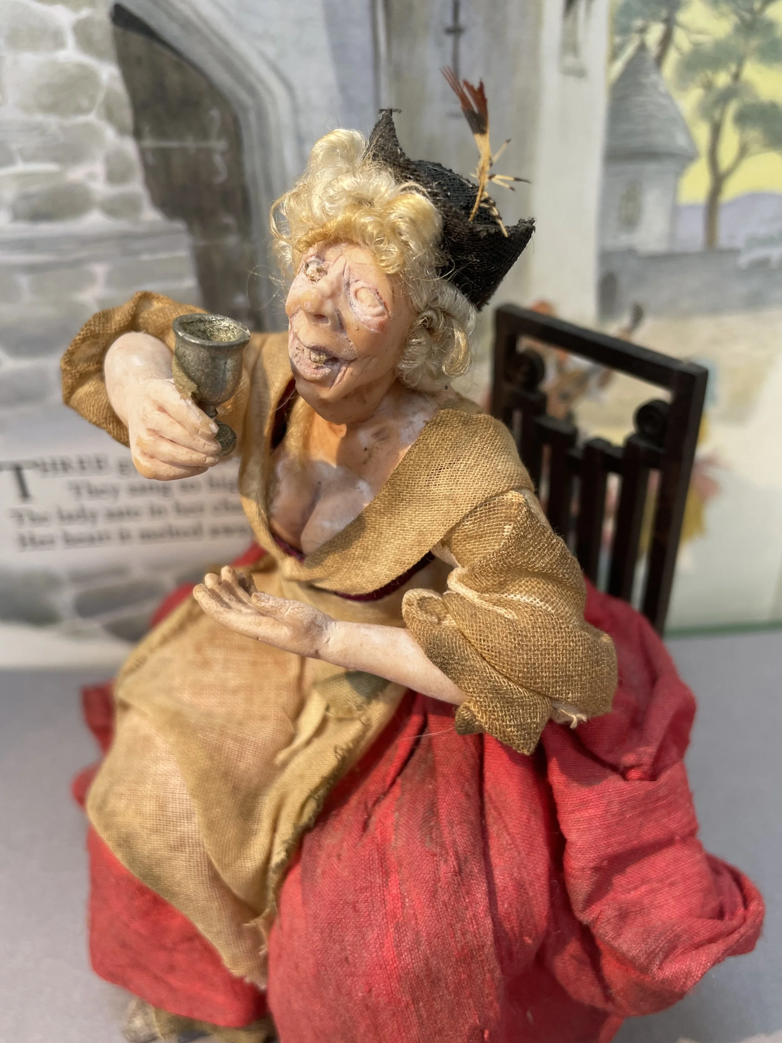 Seated lady enjoying a drink.