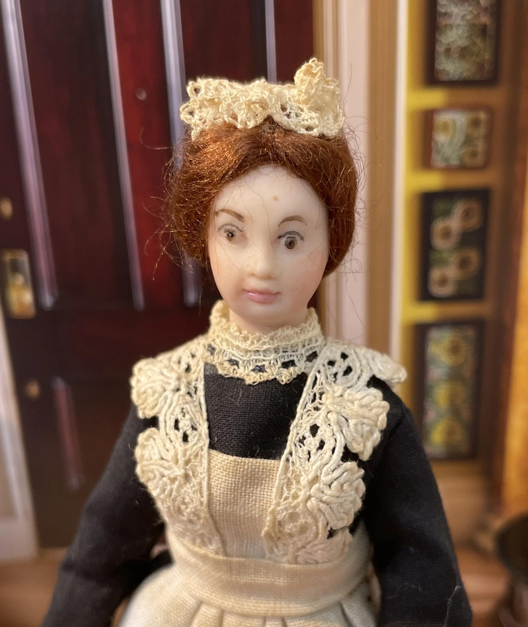 Maid in black dress with dirty apron.