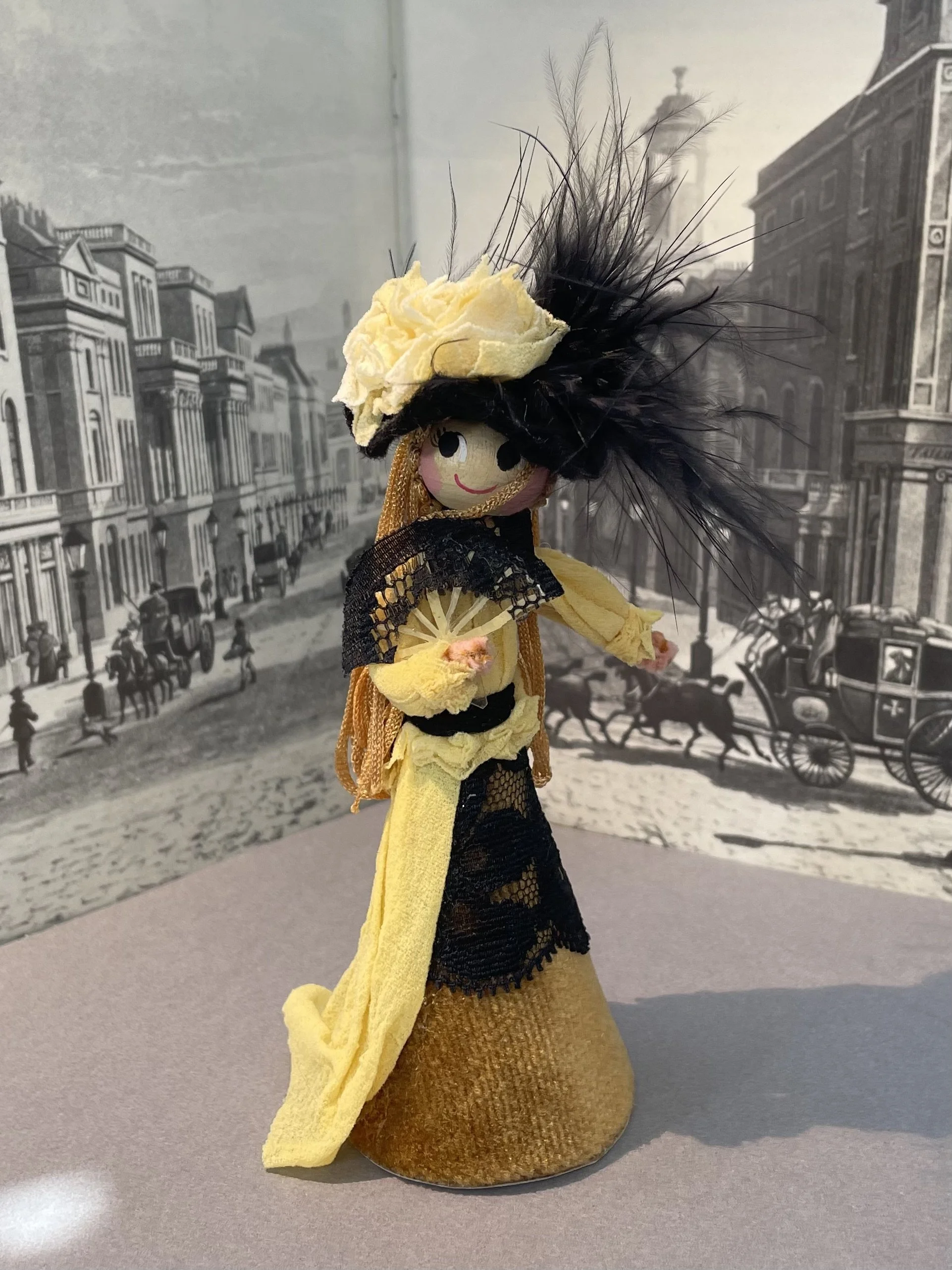 Vintage wooden head doll in yellow