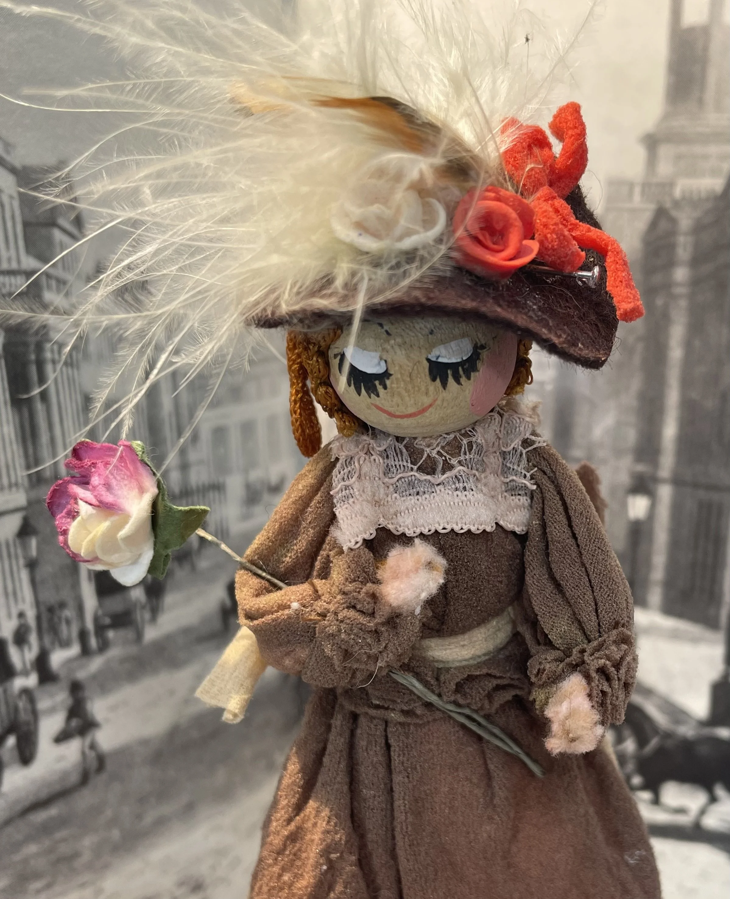 Vintage wooden headed doll in brown with flower