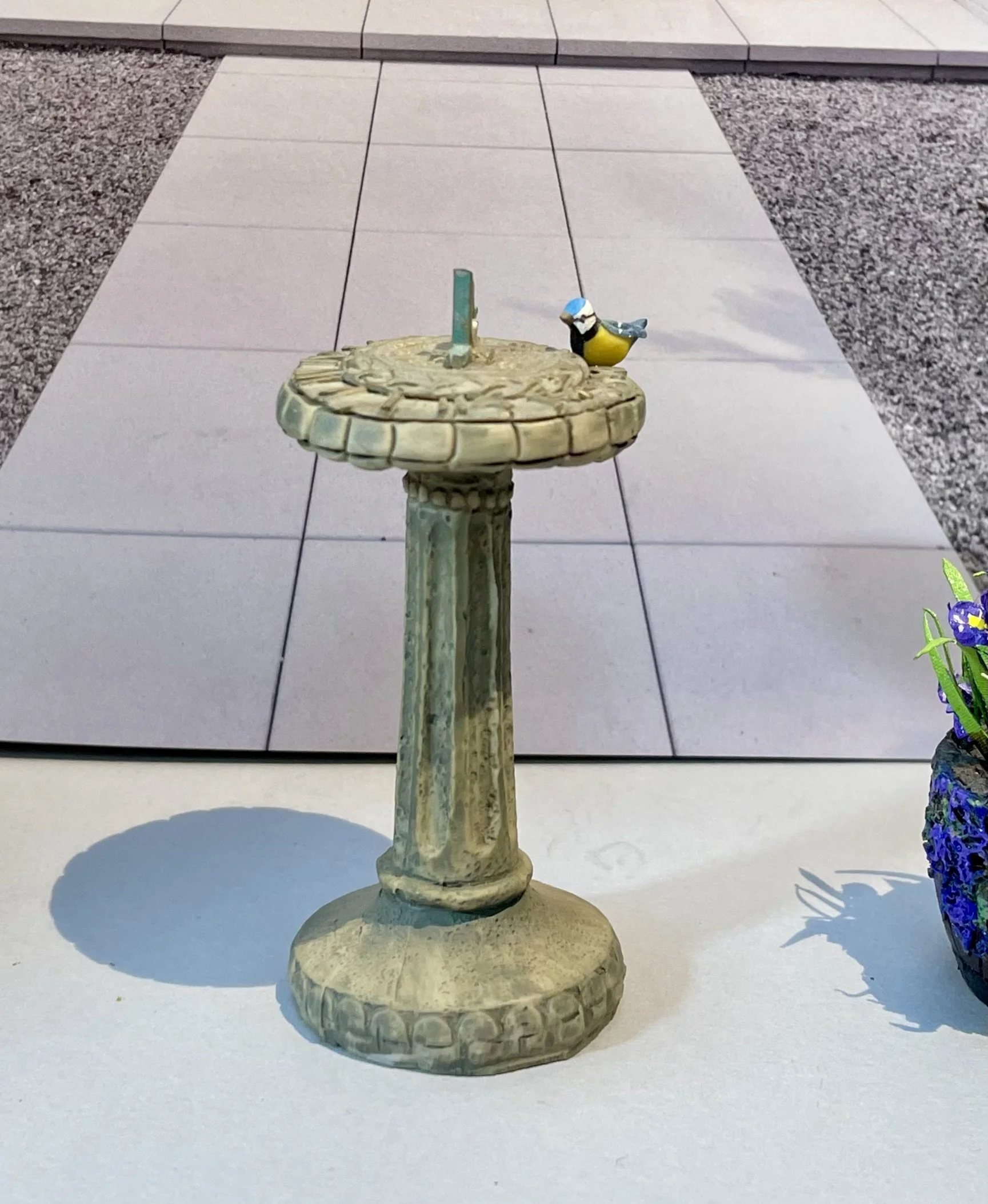 Sundial with blue tit.