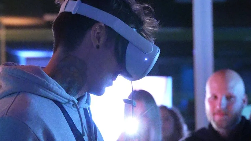 Marcello Baldari indossa visore VR in ambientazione buia durante una performance VR a Bologna.
