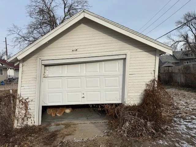 Collapsed detached garage being removed by Millard Junk Removal in Omaha, Nebraska, showing residential garage demolition and cleanup services.