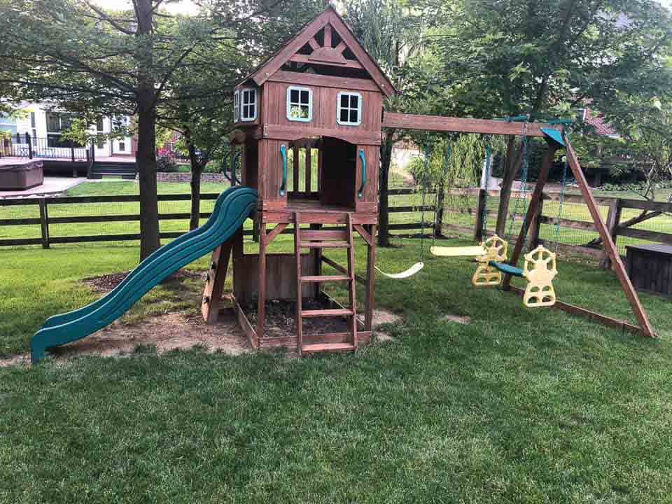Backyard playground and swing set removal by Millard Junk Removal in Omaha, specializing in playset demolition and hauling services.