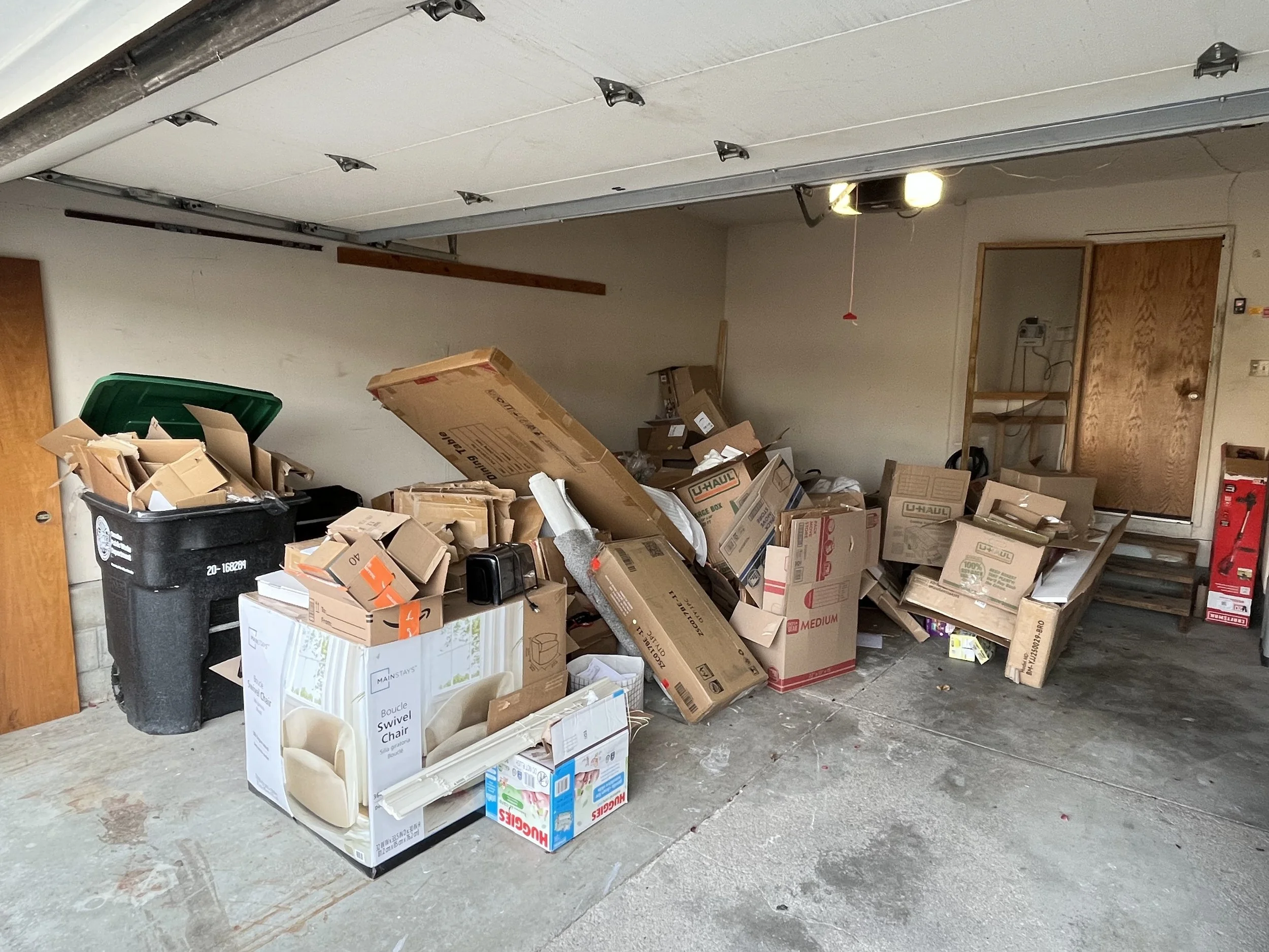 Cluttered Omaha garage packed with cardboard boxes and household items before a junk removal cleanout.