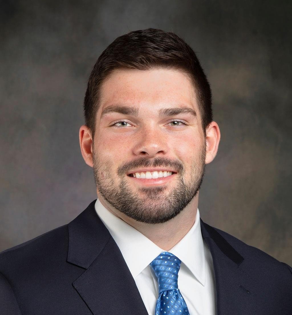 Silhouette of a person's head and shoulders against a white background.