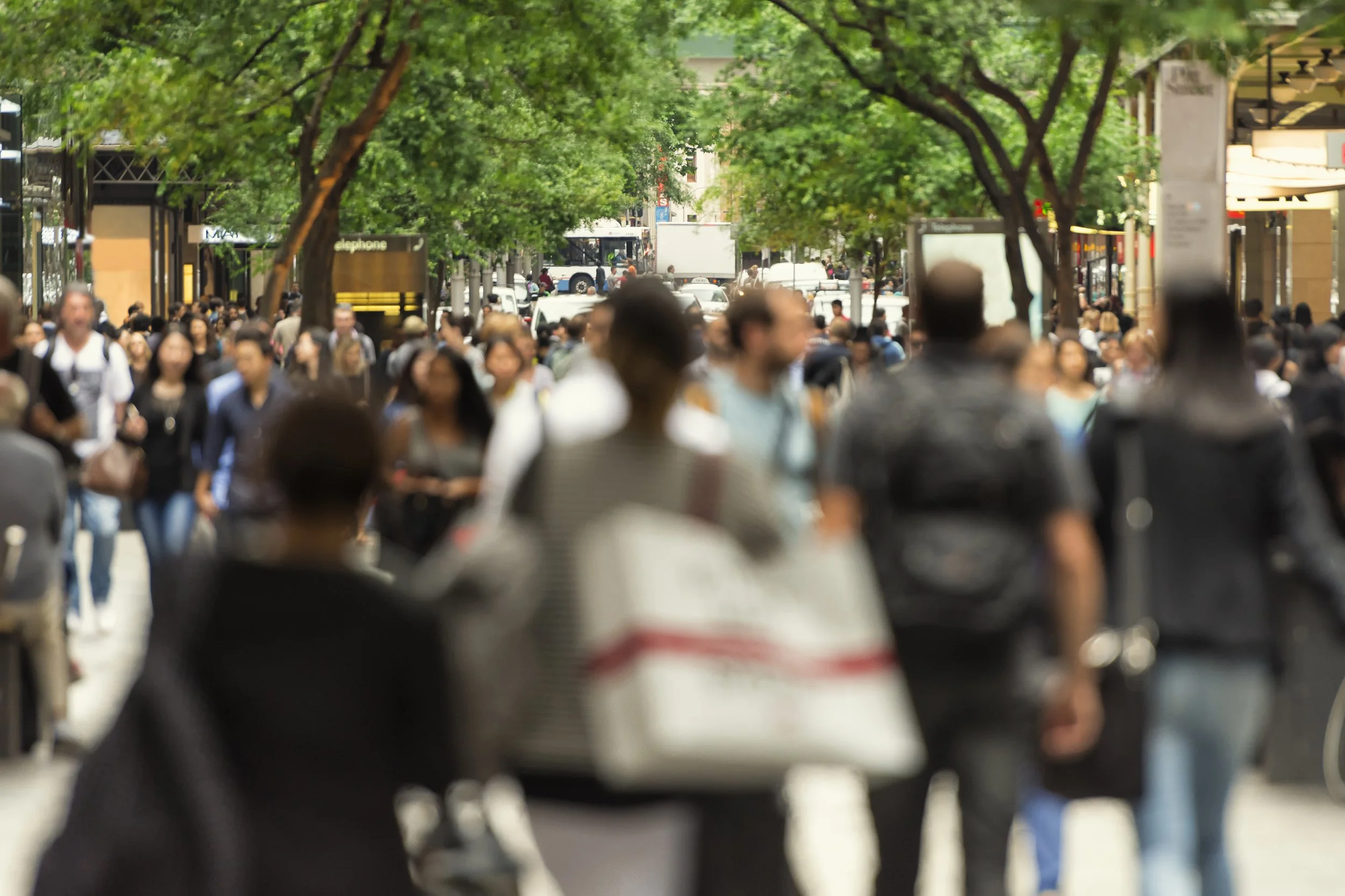 Image of a crowd of people walking through a CBD mall, with unrecognisable faces for Security Specialists Global