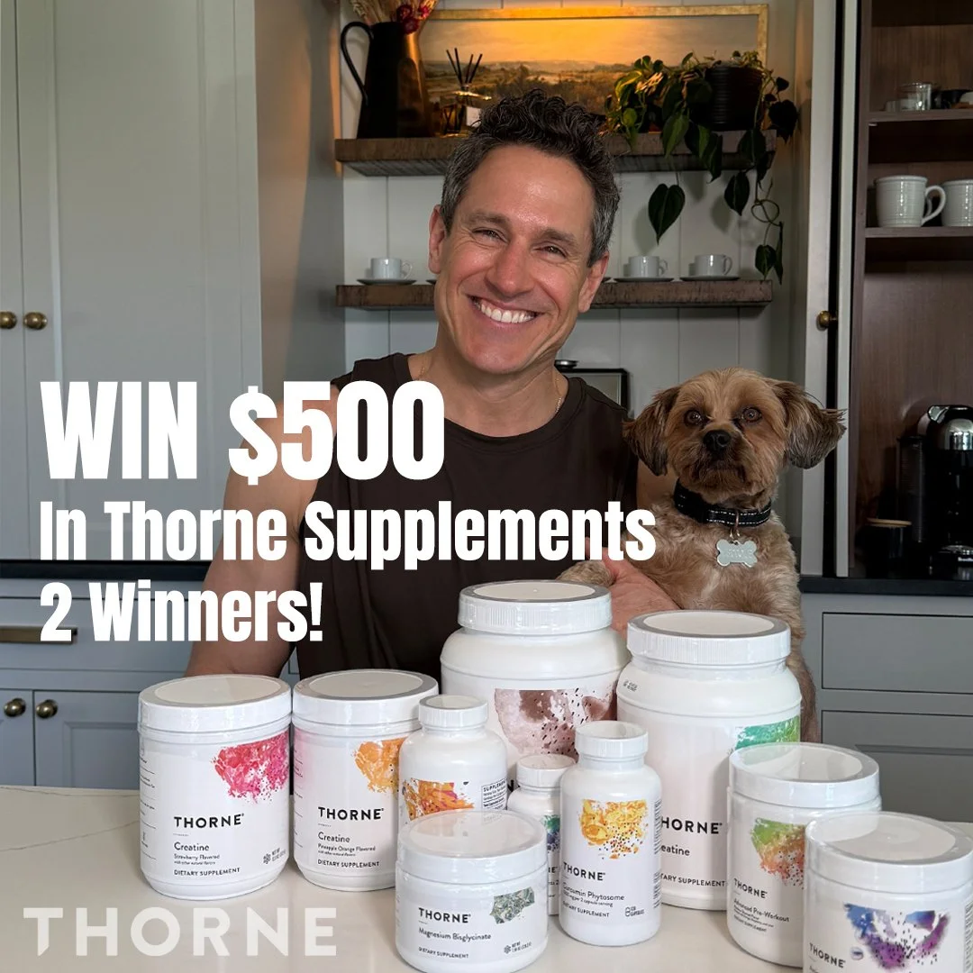 Don Saladino holding a puppy with a bunch of Thorne supplements.