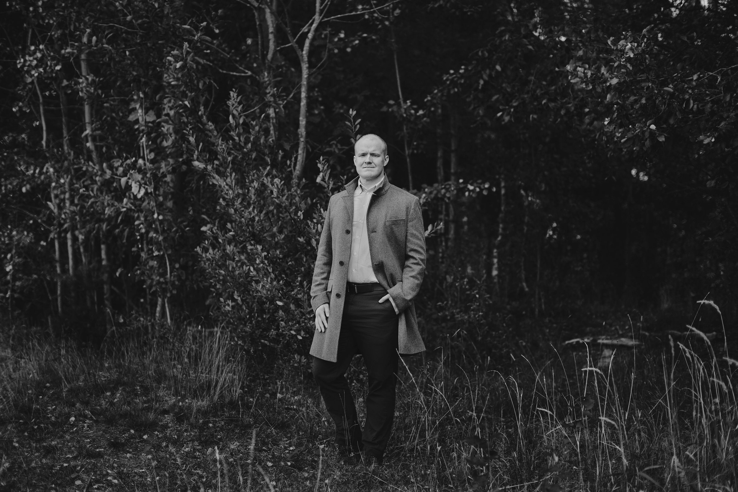 Profesjonelt bedriftsportrett helfigur utendørs i natur.