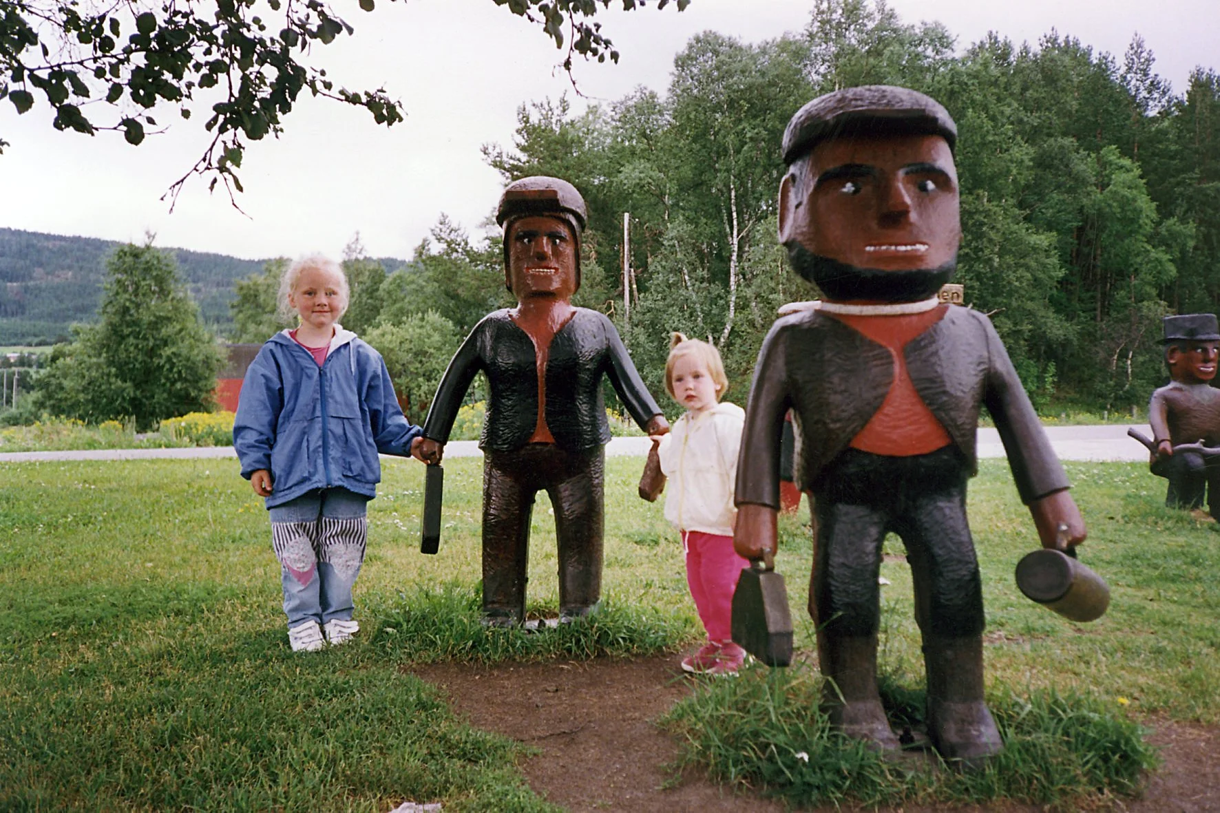 To små barn leker med statuer som ser ut som små mennesker.