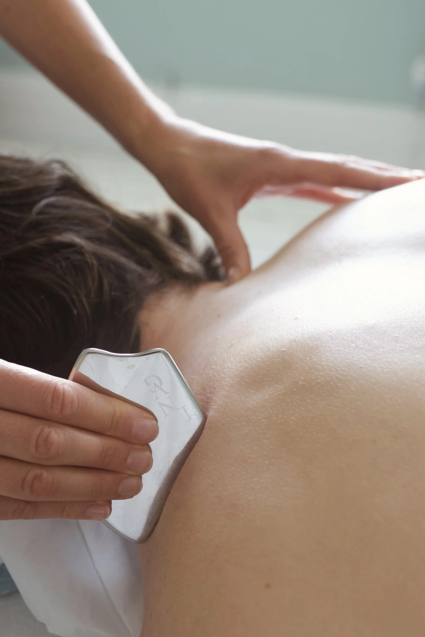 Person receiving a massage on back in a spa or massage therapy setting.