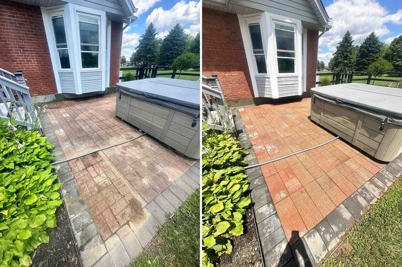 Comparison of a patio before and after cleaning, showing a brick and concrete patio with a hot tub, adjacent to a house with a bay window, under a partly cloudy sky.