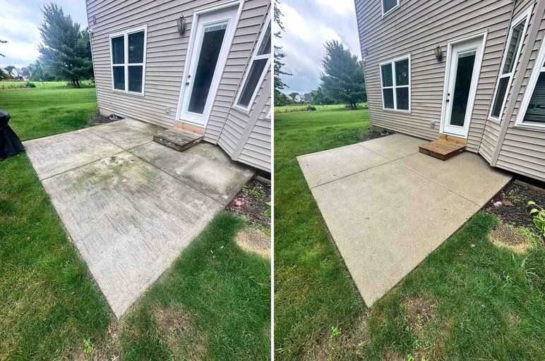 An outdoor patio area before and after cleaning and restoration. The left side shows a stained and dirty concrete patio; the right side shows a clean, restored concrete patio adjacent to a house with beige siding and a wooden step.