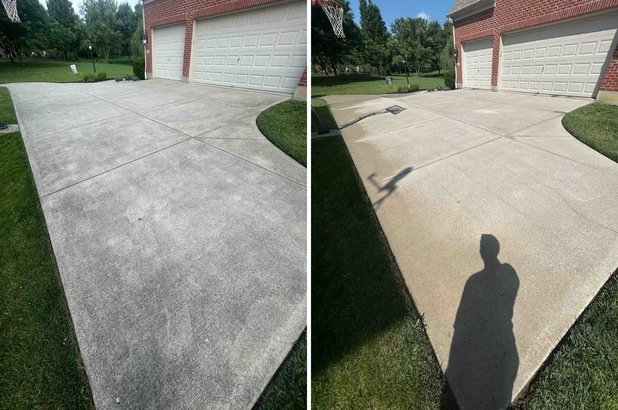 Comparison of two concrete driveways, showing different cleaning results with the left side cleaner and darker, the right side staining or dirtier.